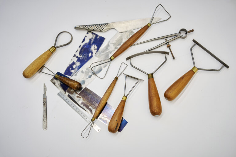 Smoothing paddles, rasps, scrapers and knives are common tools in the model shop.
