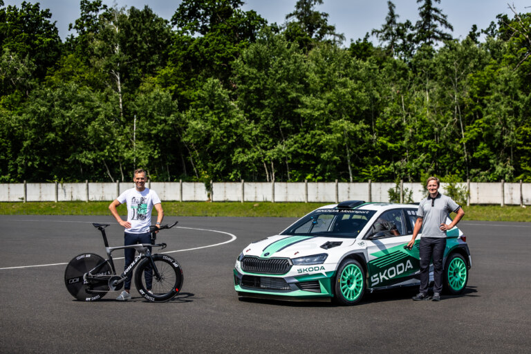 Jakub Jareš standing by the car and Zdeněk Štybar holding the bike