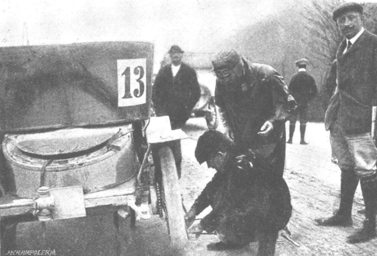 Václav Klement captured in the Algemeine Automobil-Zeitung newspaper repairing a tire on a mountain pass. The puncture was caused by a nail.
