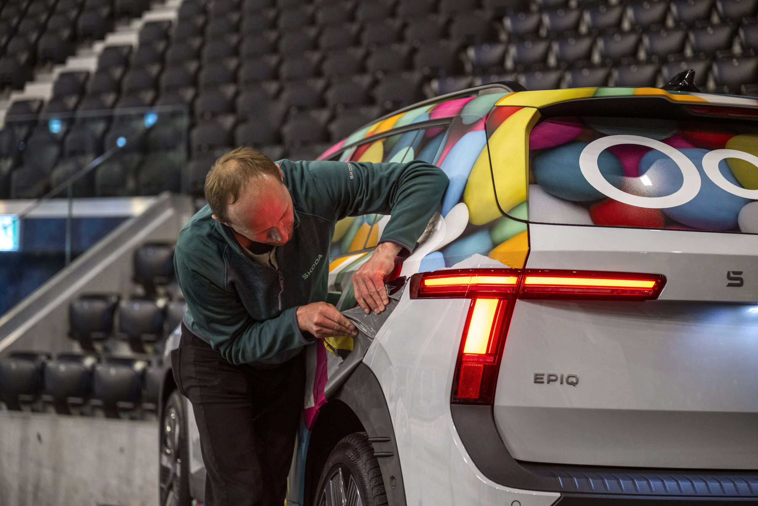 Removing the camouflage in an empty arena at the hockey championship